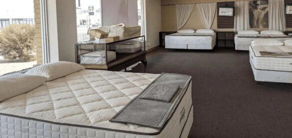 Latex mattress displayed in a bright showroom bedroom