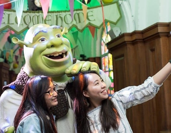 Visitors posing with Shrek at Shrek's Adventure London