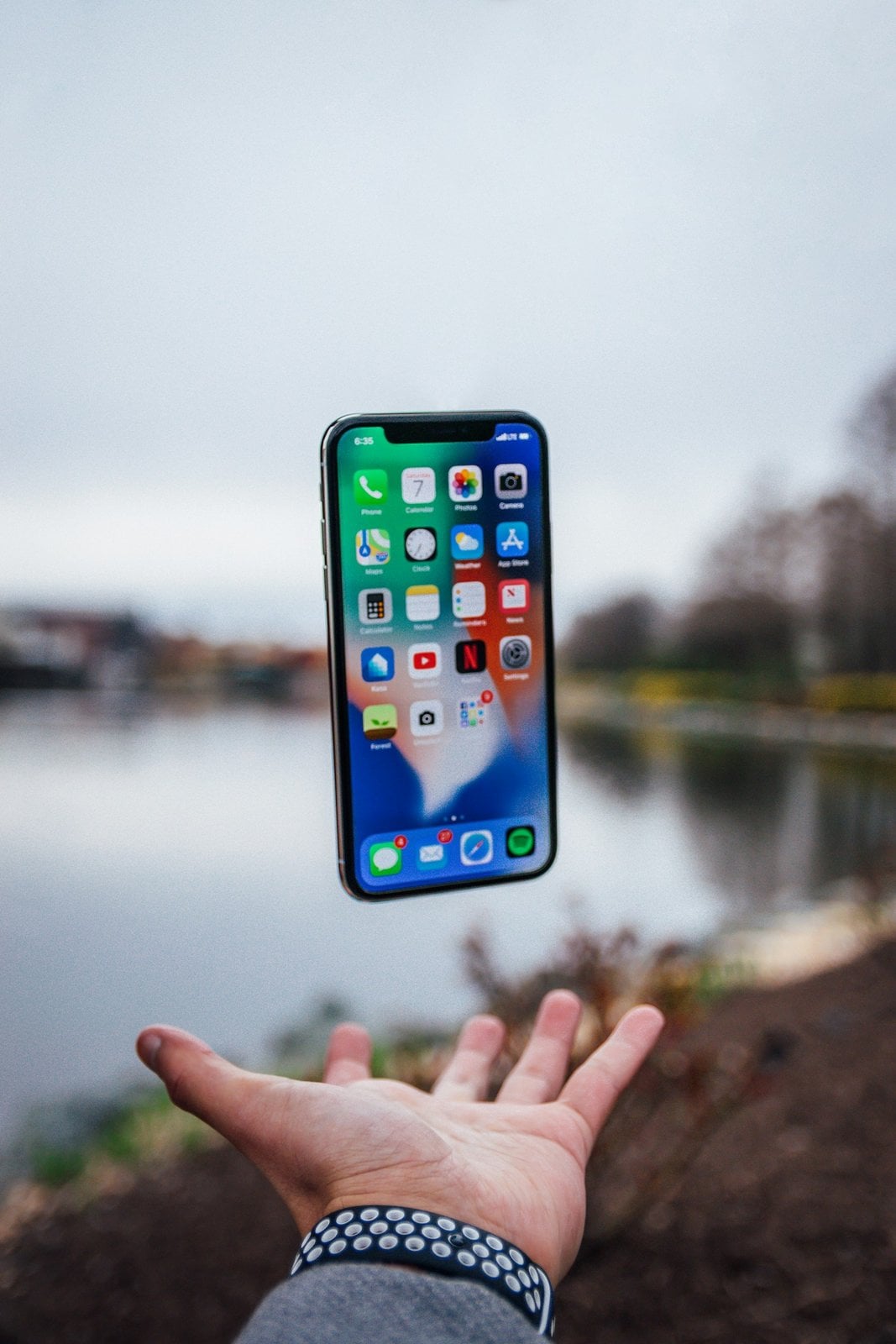 Person holding a smartphone outdoors