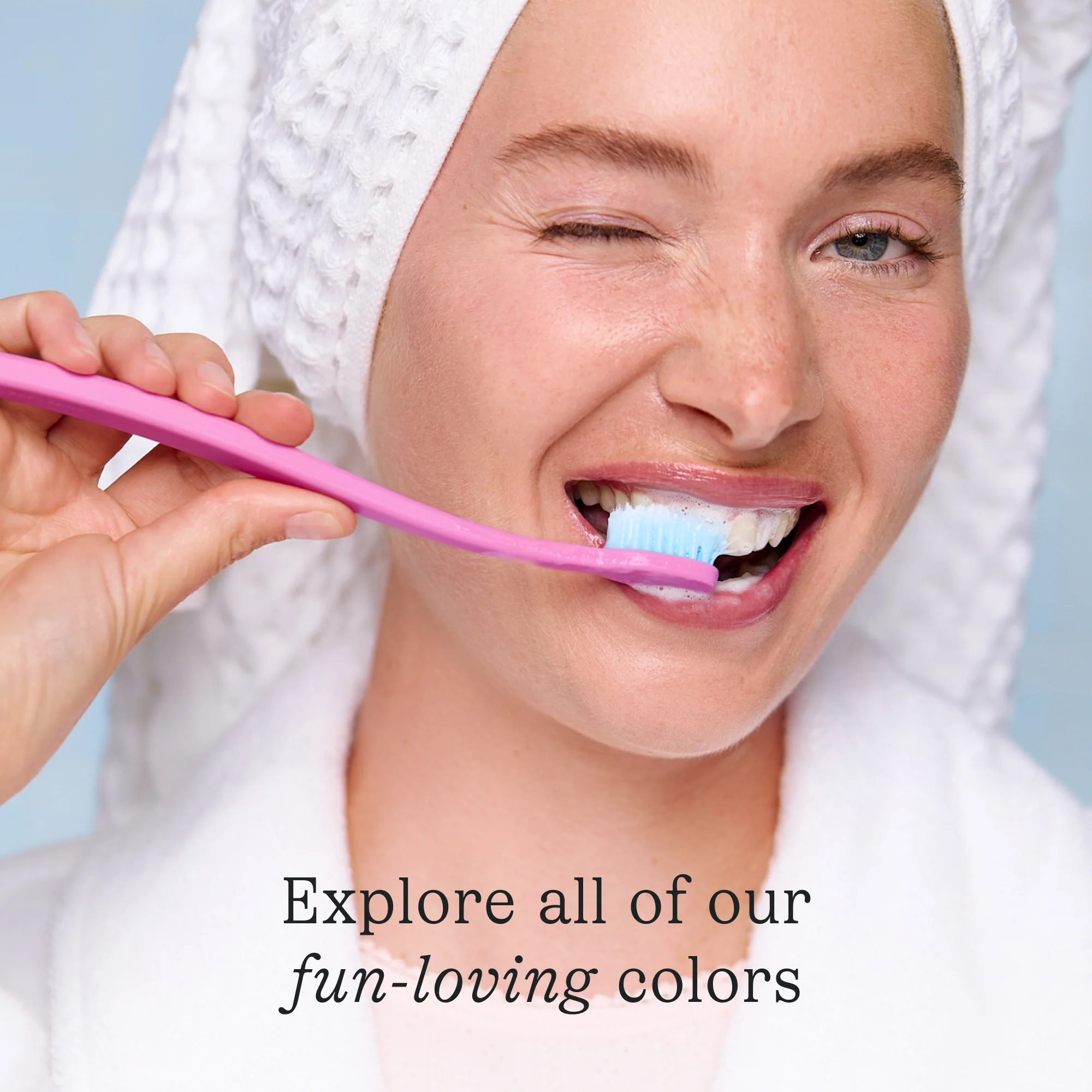 Woman brushing her teeth with a pink Cocobrush