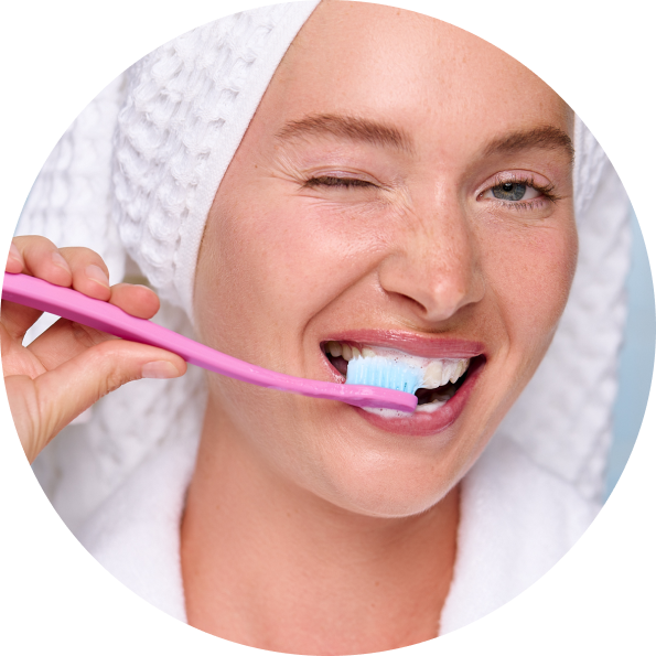 Person using a Cocobrush toothbrush
