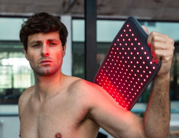 A person using a Novaa light pad on the shoulder