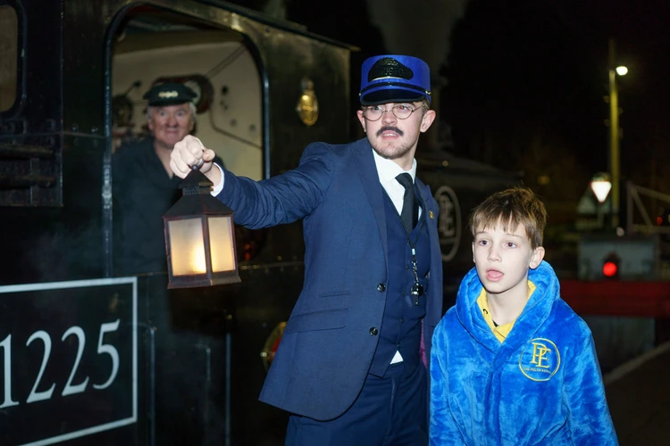 Child meeting a conductor during the Polar Express experience
