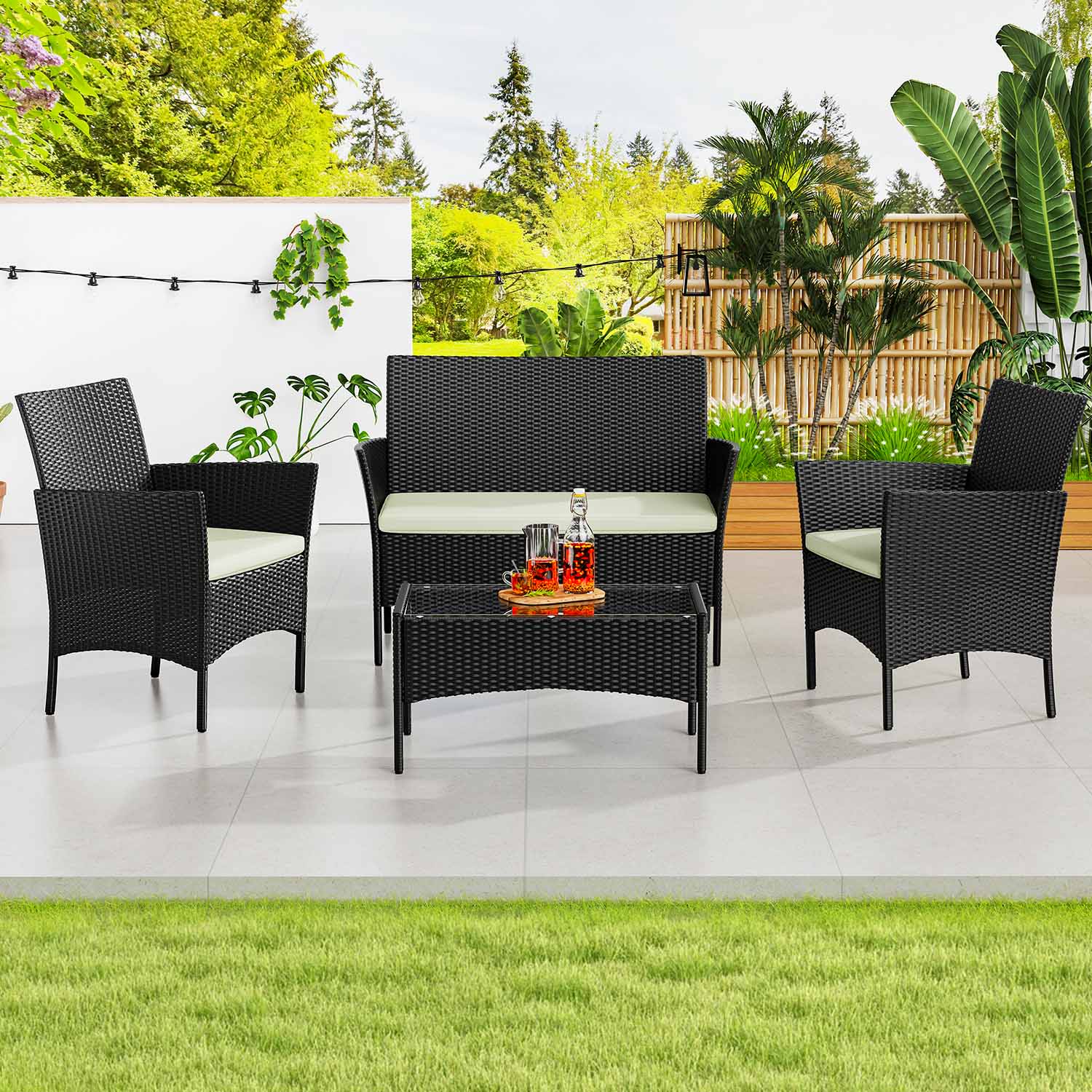 Four-piece rattan patio set with two armchairs, a double sofa and table