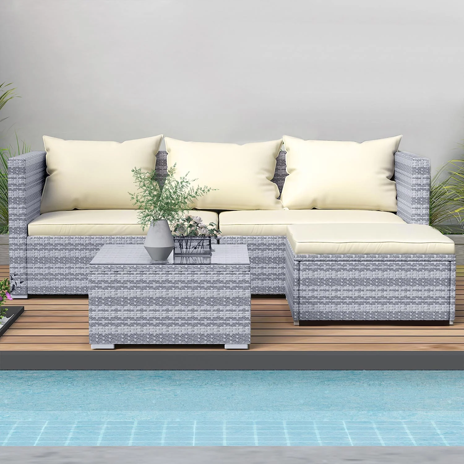 Rattan sofa, chairs and glass table arranged on a patio