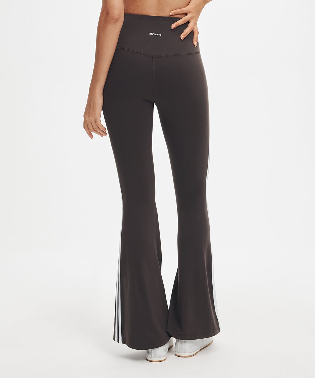 Model wearing black LunaAiry Double-Trim Flared Legging with white side stripes