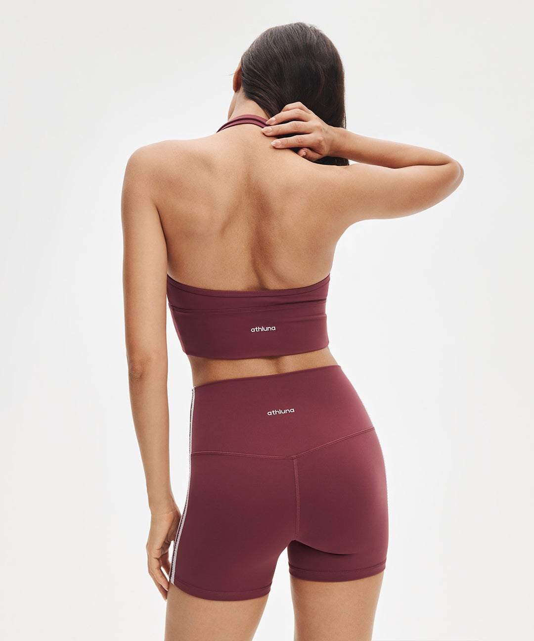 Model wearing a burgundy ShopAthluna Affiliate LunaAiry halter set