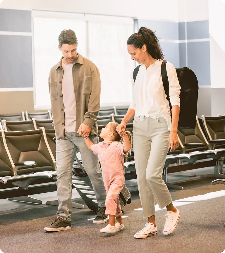 Family walking together in an airport terminal